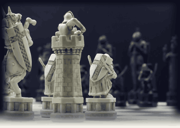 A close look at the carved rook and knight as the dark gives way to light